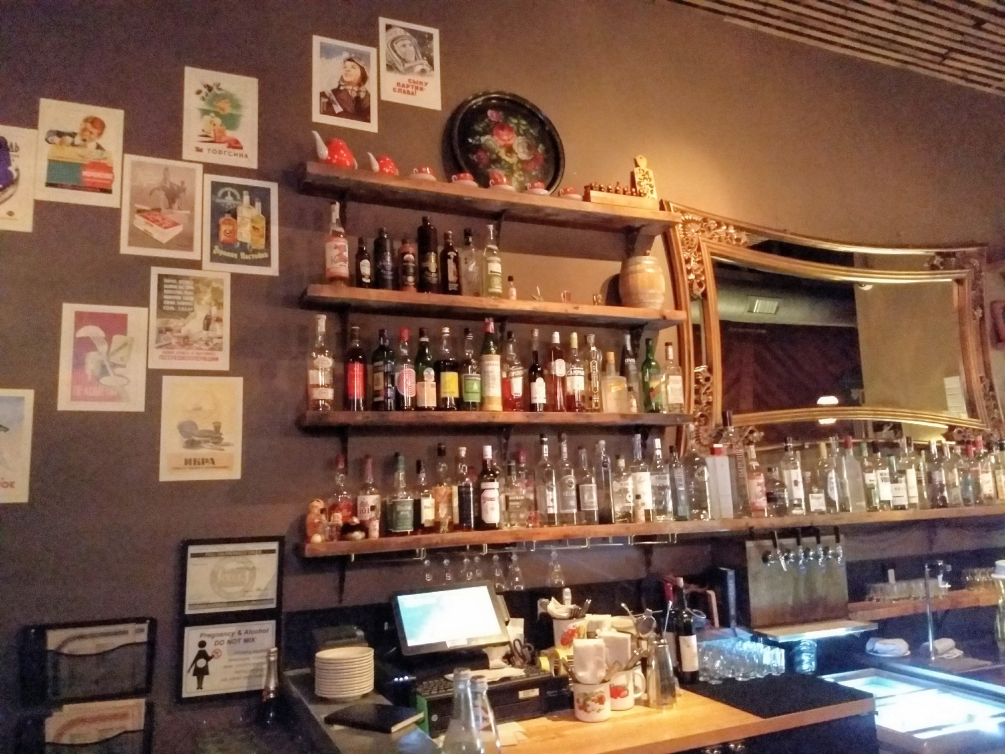 bar with bottles and a mirror at Kachinka