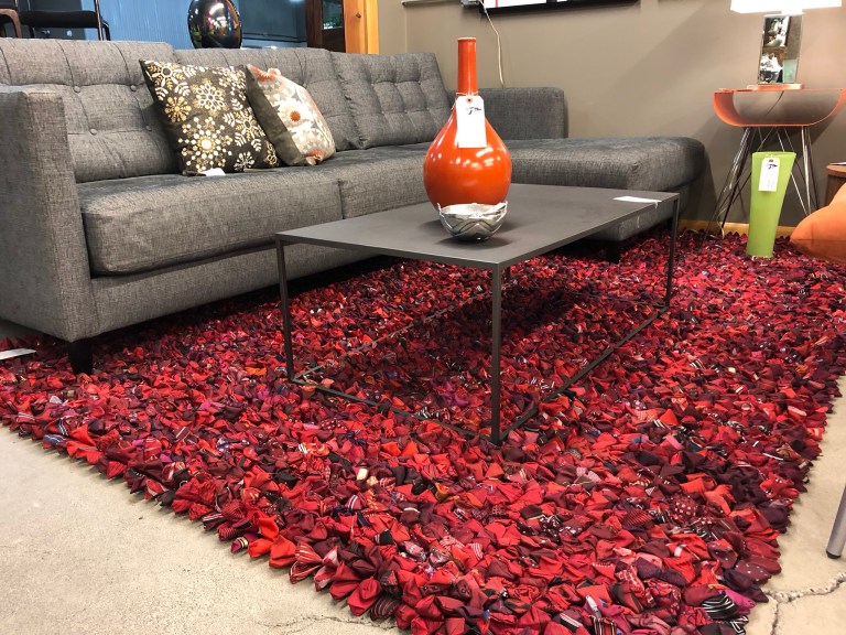 Red floor rug made of bowties