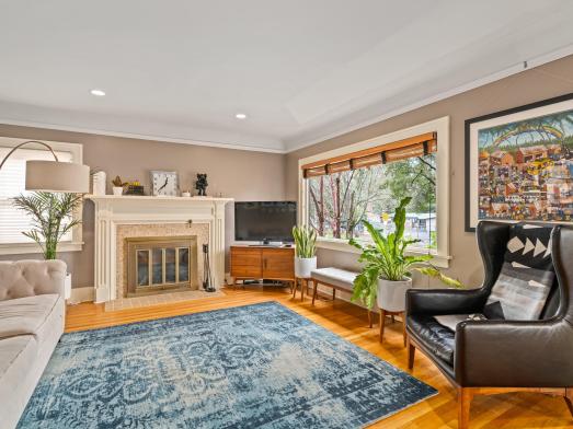 Living room wood floors picture window fireplace