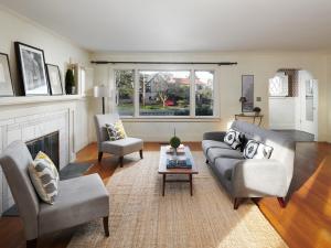Living room interior hardwood floors and fireplace with furniture and window