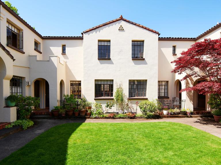 Exterior courtyard Carl L Linde designed Salerno building condo for sale