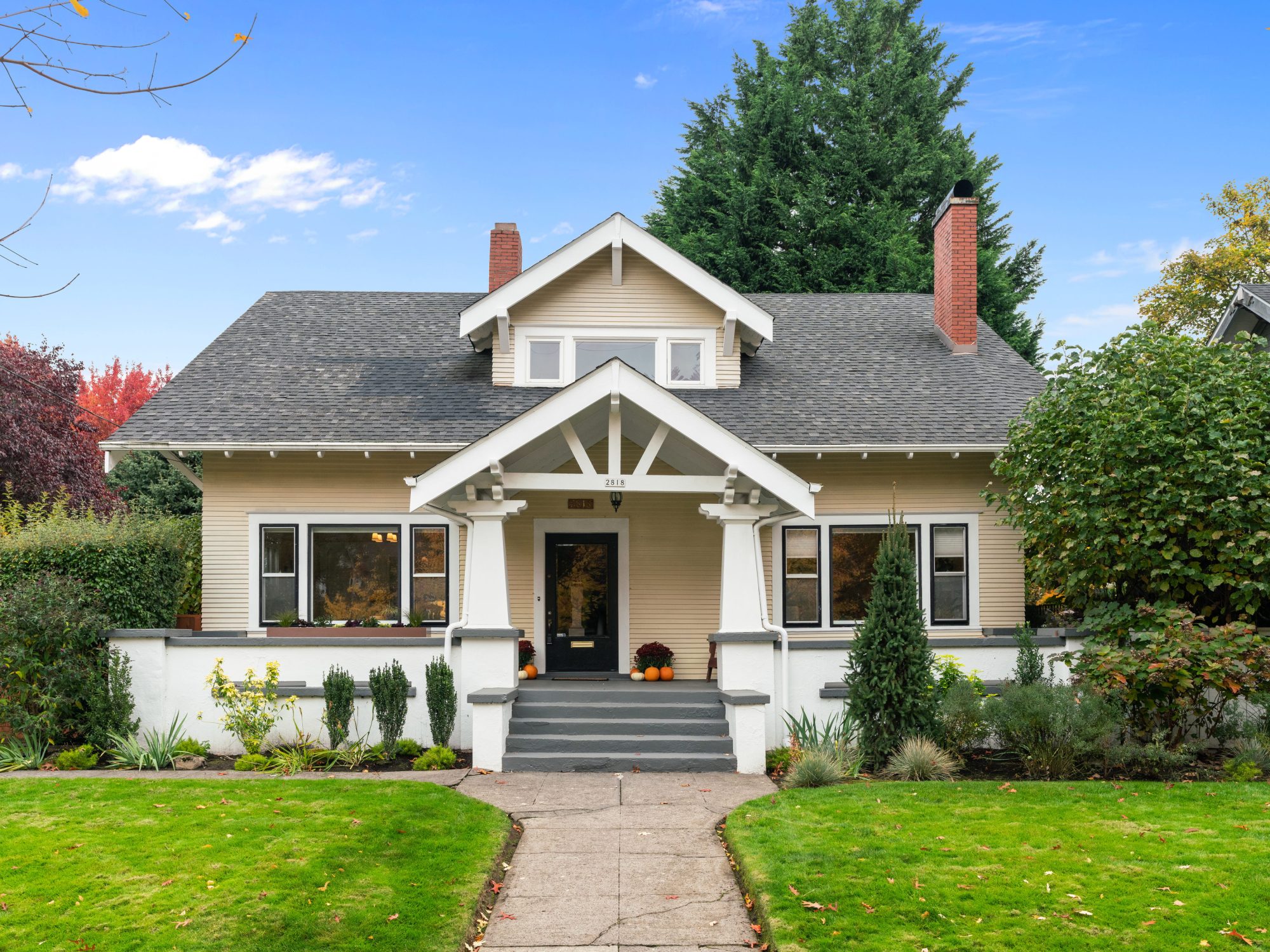 Irvington Craftsman home exterior in Northeast Portland with large porch and bright green grass