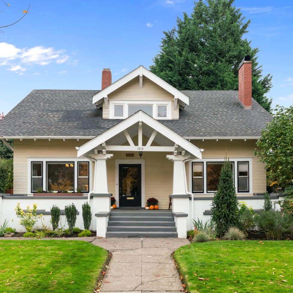 Irvington Craftsman home exterior in Northeast Portland with large porch and bright green grass