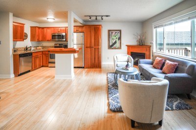 interior of condo in st johns portland with kitchen, fireplace and couch