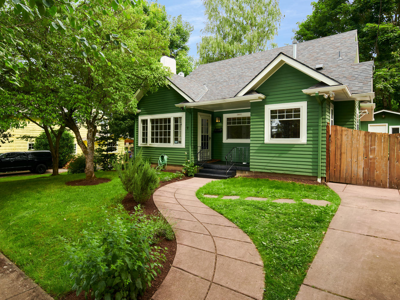 Exterior of Craftsman home in Eastmoreland Portland, green grass, walkway to front door