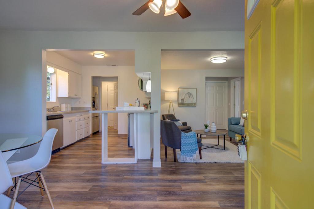Interior of a home with wood floors and open living space, kitchen and living room