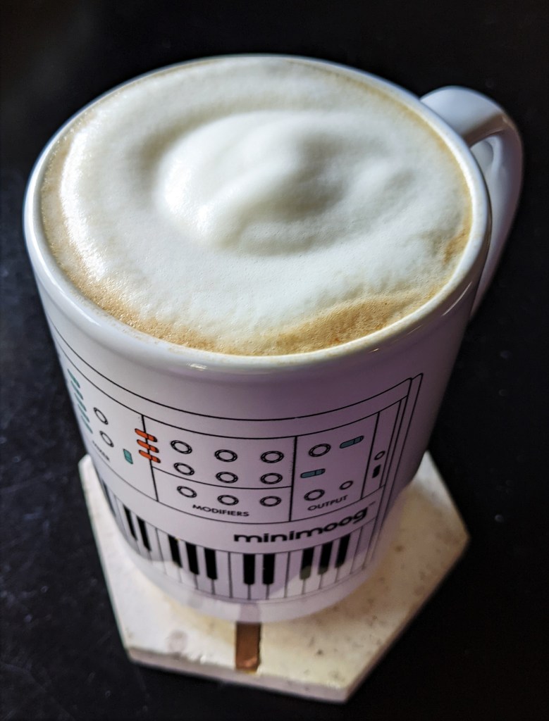 Mug of coffee topped with frothy soy milk
