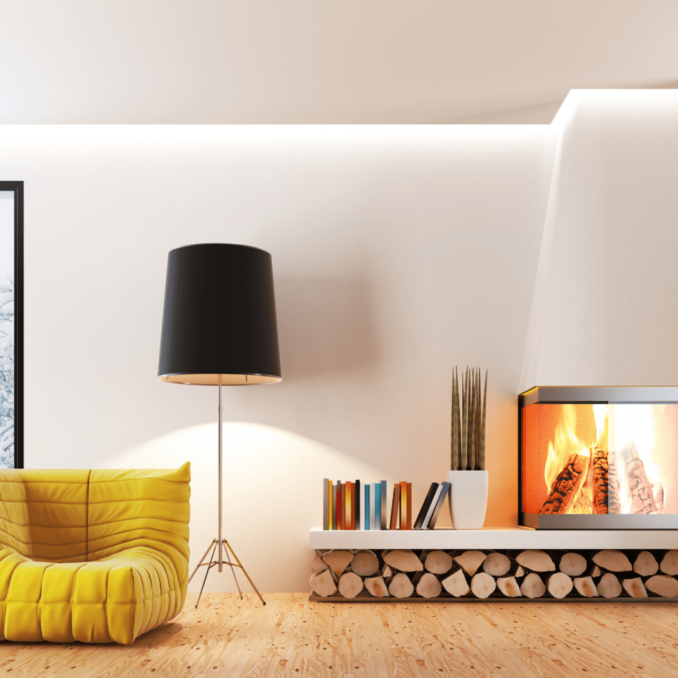 Living room with yellow cushy chair, lamp and fireplace