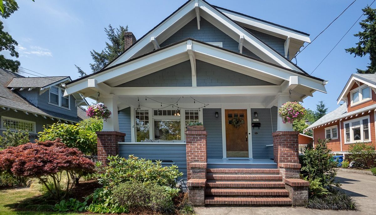 Exterior of Craftsman bungalow home with brick steps up to porch