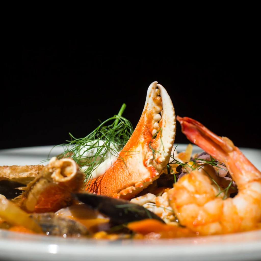bowl of cioppino seafood stew with crab and shrimp